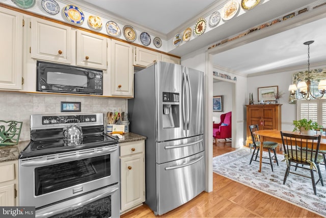 kitchen with dark stone counters, decorative backsplash, a chandelier, and stainless steel appliances