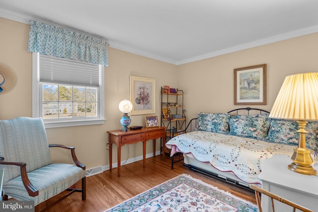 bedroom with hardwood / wood-style floors and ornamental molding