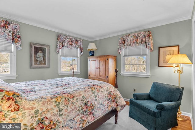 bedroom featuring crown molding and multiple windows