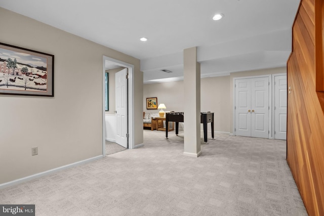 basement featuring light carpet