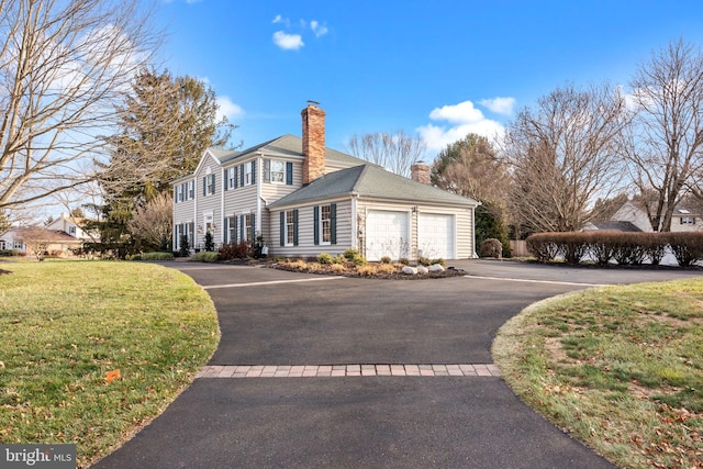 view of side of home with a garage and a lawn