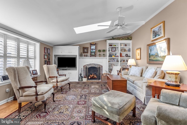 living room featuring ceiling fan, a brick fireplace, crown molding, lofted ceiling, and hardwood / wood-style flooring