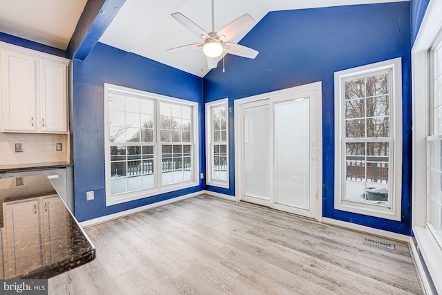 interior space with vaulted ceiling with beams, ceiling fan, and light hardwood / wood-style flooring