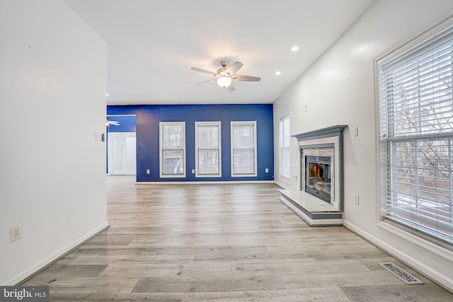 unfurnished living room featuring light wood-type flooring and ceiling fan