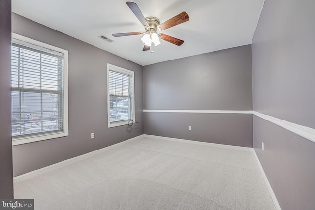 spare room featuring carpet flooring and ceiling fan