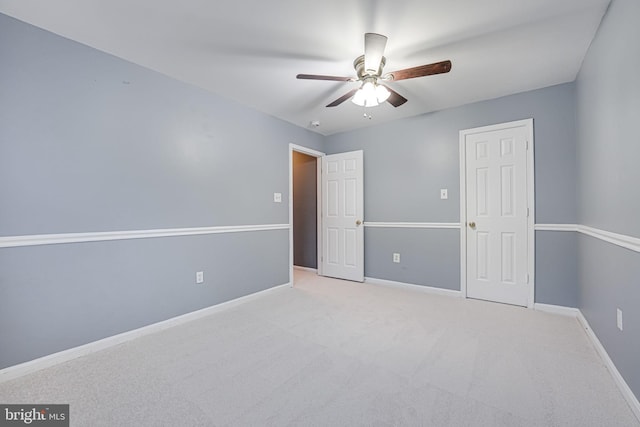 unfurnished bedroom with ceiling fan and light colored carpet