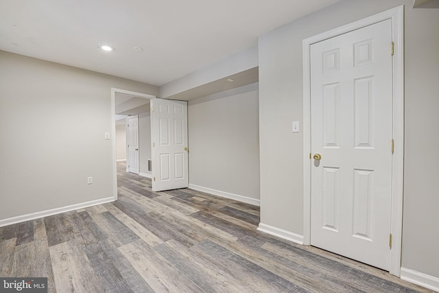 empty room with hardwood / wood-style flooring