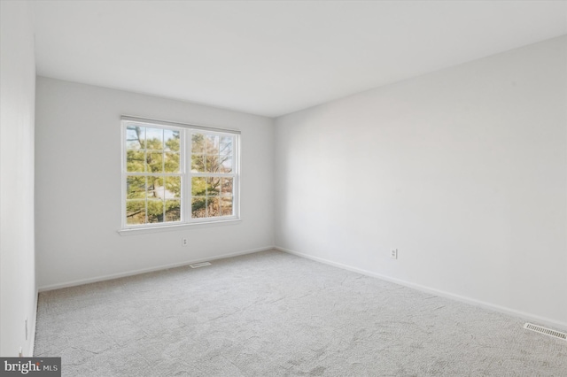 unfurnished room with light carpet