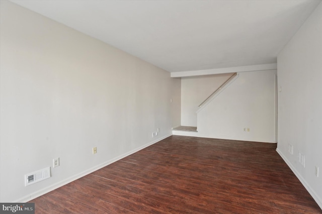 unfurnished room with dark hardwood / wood-style flooring