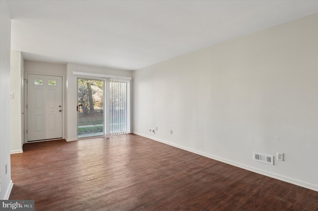 spare room featuring dark hardwood / wood-style flooring