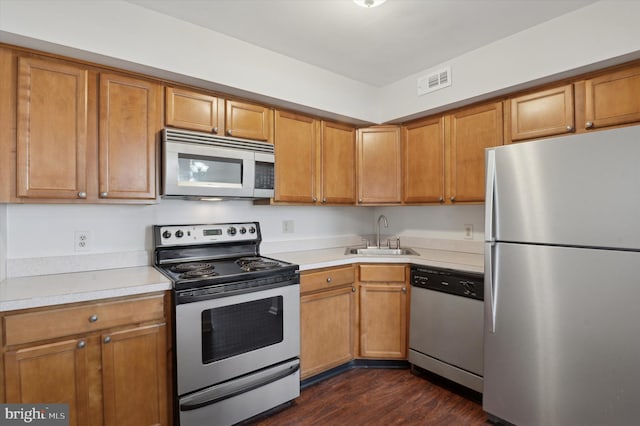 kitchen featuring dark hardwood / wood-style flooring, sink, and appliances with stainless steel finishes