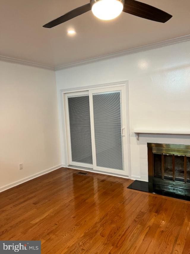 unfurnished living room with wood-type flooring and ornamental molding