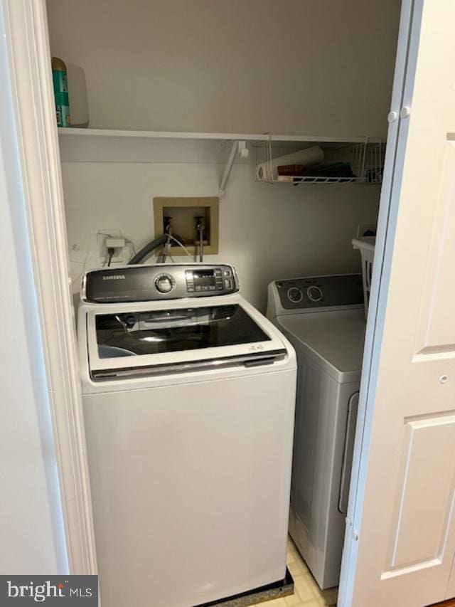 laundry room with separate washer and dryer