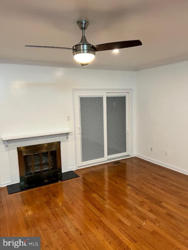 unfurnished living room featuring hardwood / wood-style flooring, ceiling fan, and crown molding