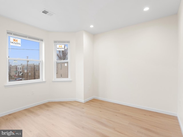 unfurnished room with light wood-type flooring