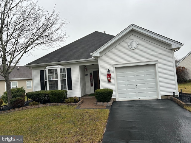 view of front of property featuring a garage and a front yard