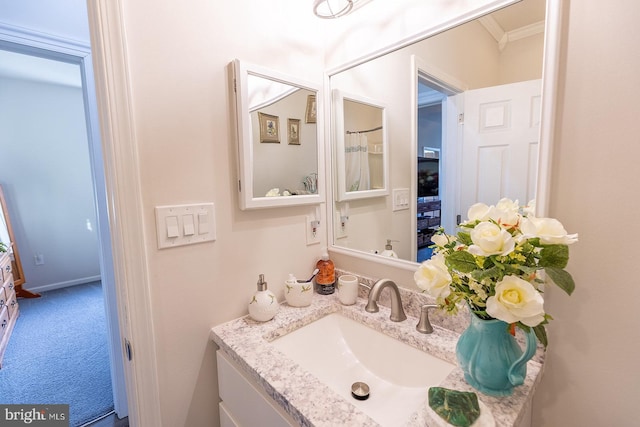 bathroom with vanity and crown molding