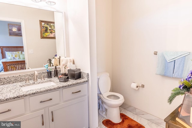 bathroom with vanity and toilet