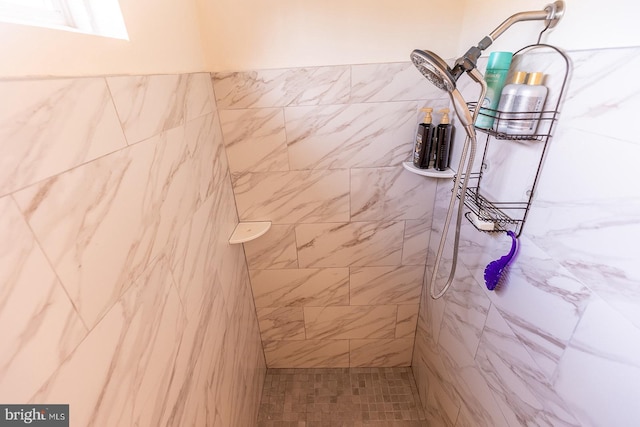 bathroom with tiled shower