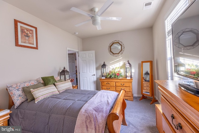 bedroom with ceiling fan and dark carpet