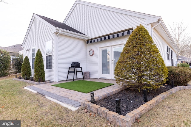 exterior space with a lawn and a patio