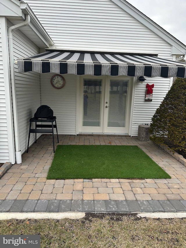 doorway to property featuring a patio and french doors