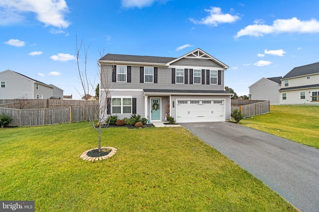 view of front of house with a front lawn and a garage