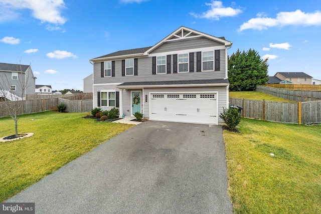 view of front of home with a front lawn and a garage