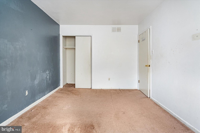 unfurnished bedroom with a closet and carpet