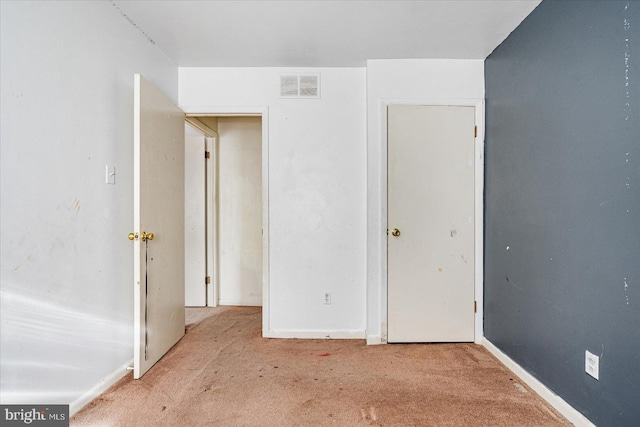 unfurnished bedroom with light colored carpet