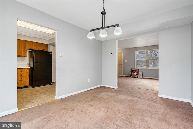 unfurnished dining area featuring light colored carpet