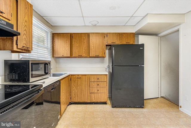 kitchen featuring ventilation hood, a drop ceiling, and black appliances