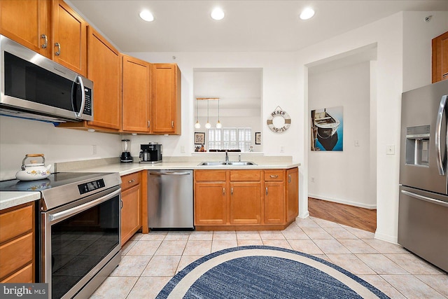 kitchen featuring light tile patterned flooring, stainless steel appliances, and sink