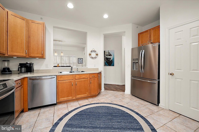 kitchen featuring a chandelier, sink, stainless steel appliances, and light tile patterned flooring