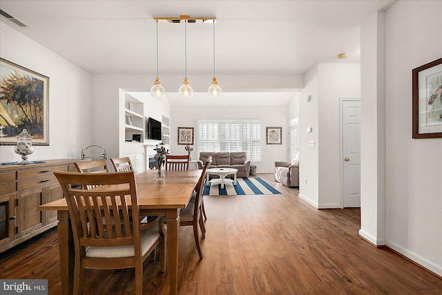 dining space with dark hardwood / wood-style floors