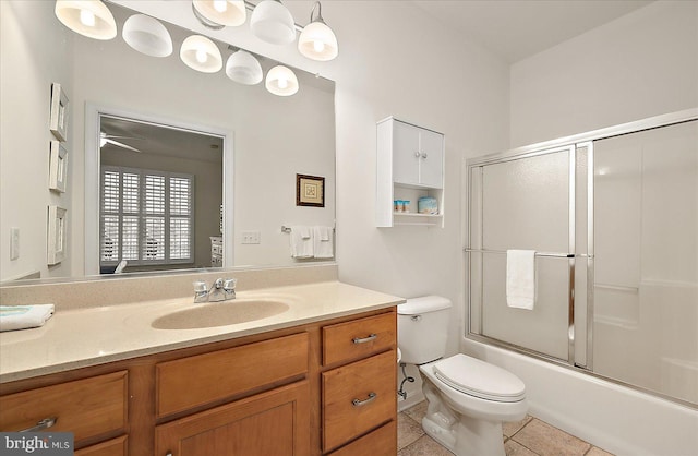 full bathroom with ceiling fan, enclosed tub / shower combo, tile patterned floors, toilet, and vanity