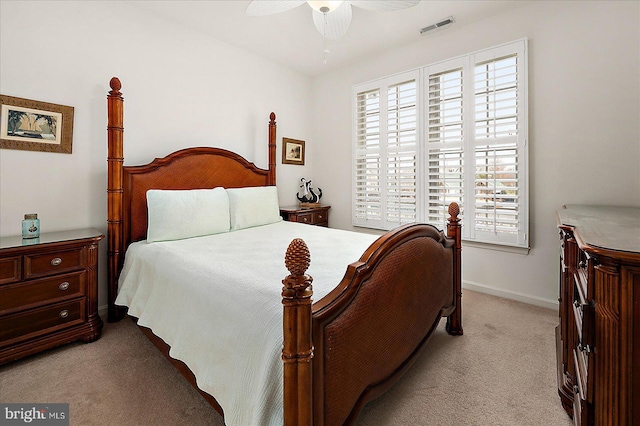 bedroom featuring light colored carpet and ceiling fan