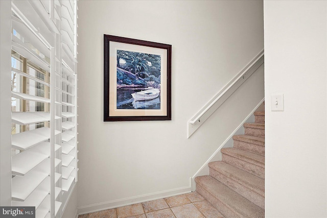 staircase featuring tile patterned flooring