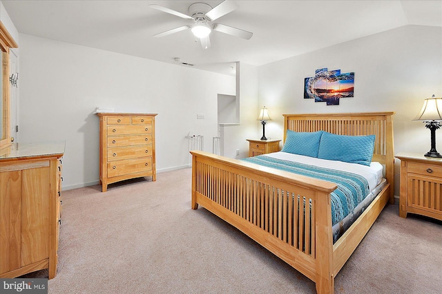 bedroom with ceiling fan, light colored carpet, and vaulted ceiling