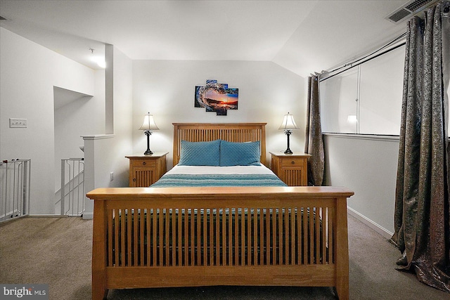 bedroom featuring light colored carpet and lofted ceiling