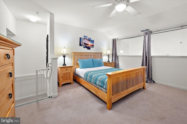 carpeted bedroom with ceiling fan and vaulted ceiling