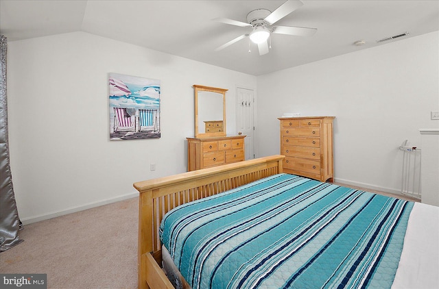 carpeted bedroom with ceiling fan and vaulted ceiling