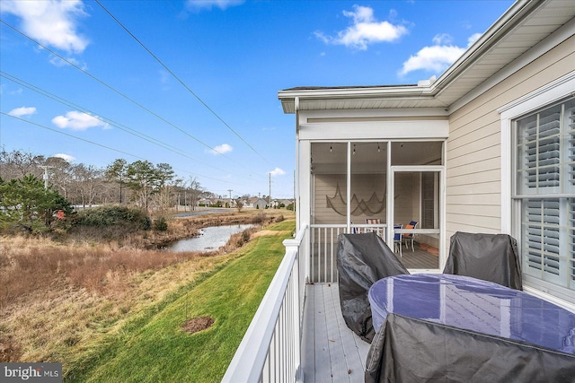 wooden deck with a yard and a sunroom