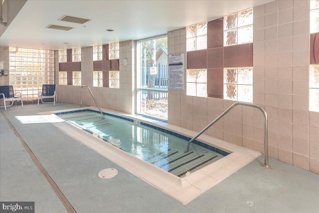 view of swimming pool featuring a jacuzzi