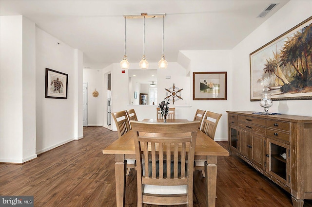 dining space with dark hardwood / wood-style flooring