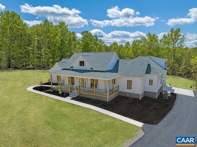 view of front of home featuring cooling unit, a porch, and a front lawn