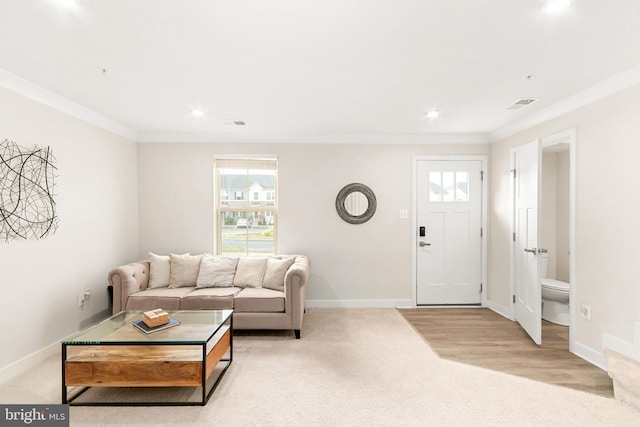 carpeted living room featuring ornamental molding