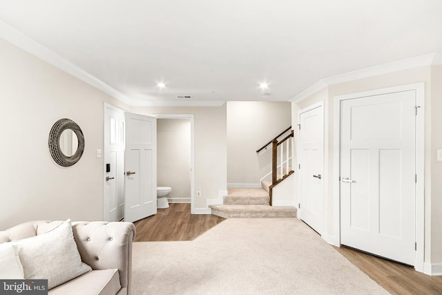 foyer featuring light hardwood / wood-style flooring and ornamental molding