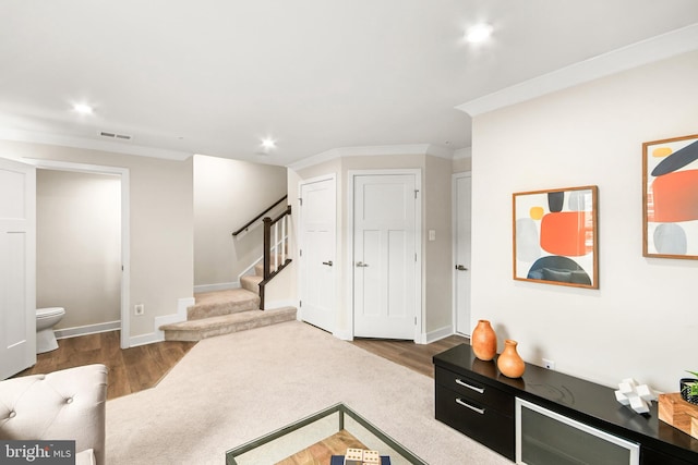 living room with hardwood / wood-style floors and ornamental molding