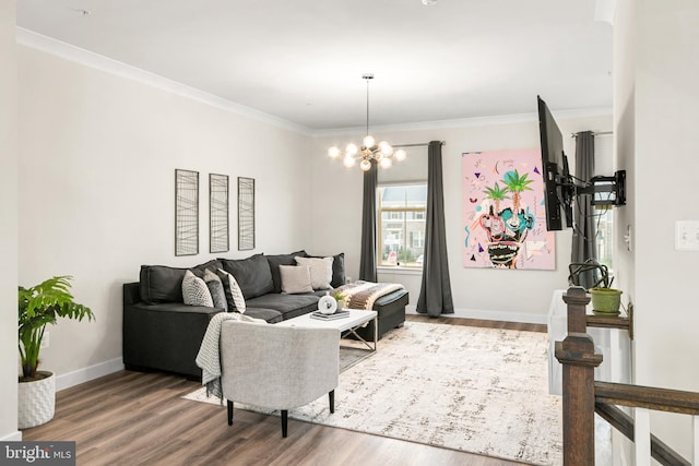 living room featuring wood-type flooring, a chandelier, and ornamental molding